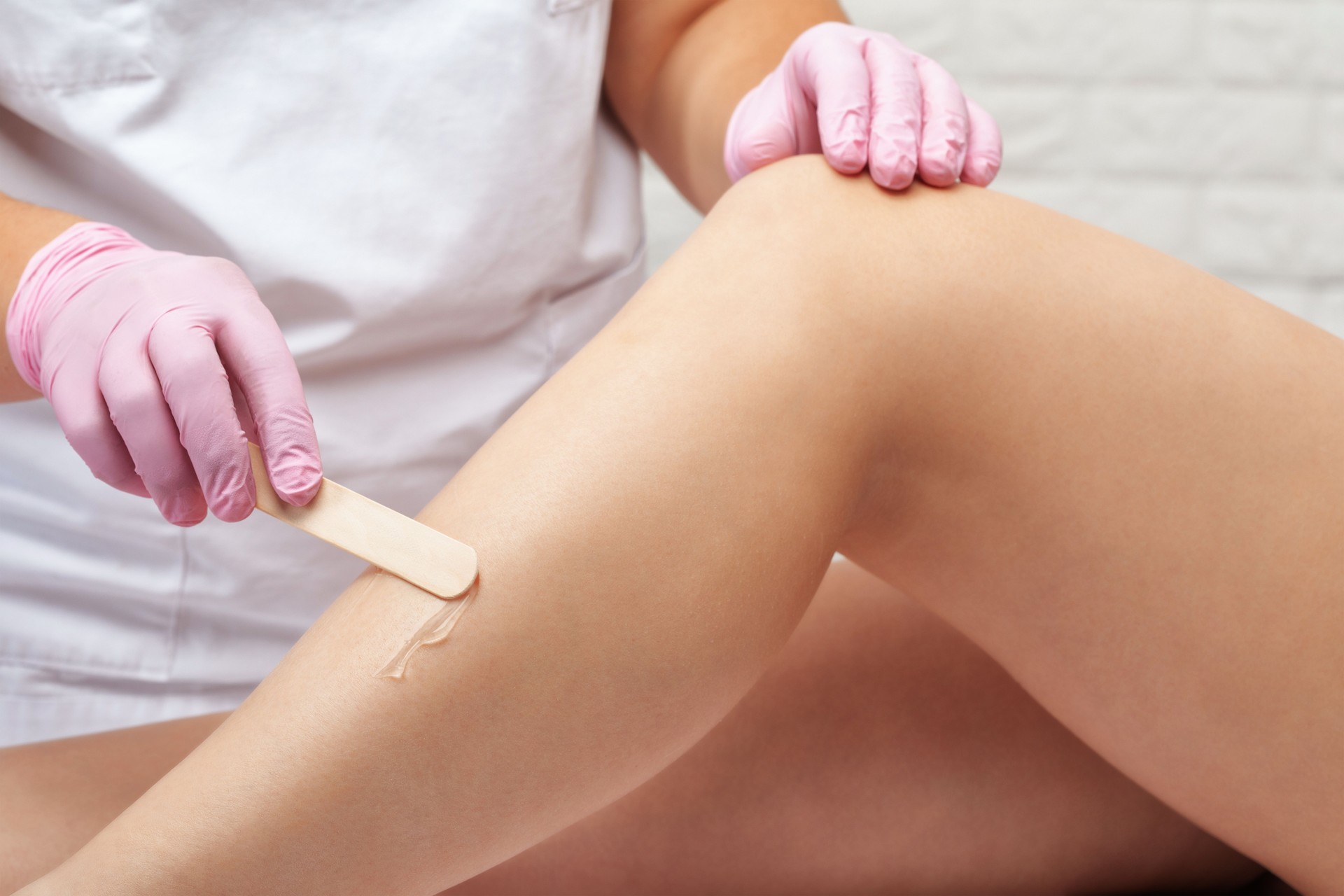 Hair removal procedure on a woman's body. Beautician doing laser rejuvenation in a beauty salon. Removing unwanted body hair. Hardware ipl cosmetology